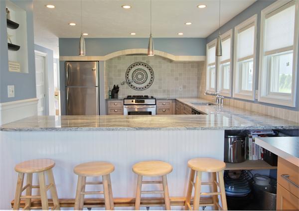 10 Cliff Estates Road, Unit 10 Scituate, MA 02066 - Photo 4 of 26 a kitchen with a table chairs sink and cabinets