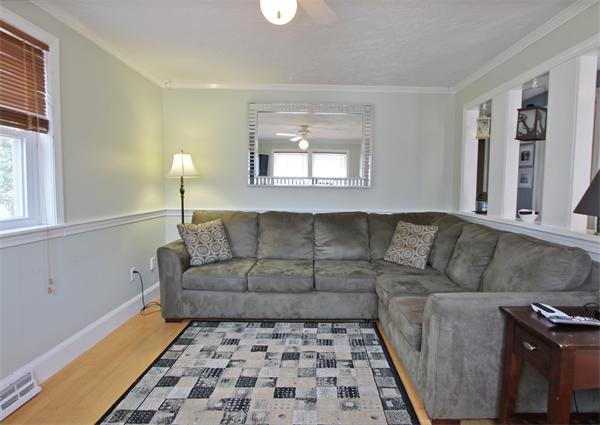 10 Cliff Estates Road, Unit 10 Scituate, MA 02066 - Photo 7 of 26 a living room with a couch and a rug