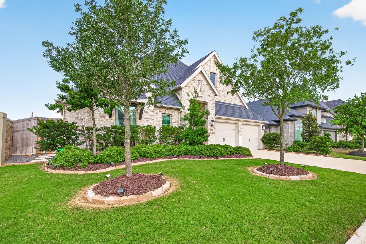 29730 Smoky Ridge Road Fulshear, TX 77441 - Photo 3 of 29 Professional landscape design and added privacy of a corner lot with no neighbors on one side