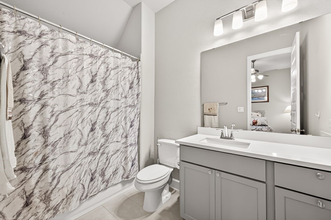 29730 Smoky Ridge Road Fulshear, TX 77441 - Photo 6 of 29 One of the 3 full bathrooms, all with upgraded engineered quartz counters and brilliant fixtures
