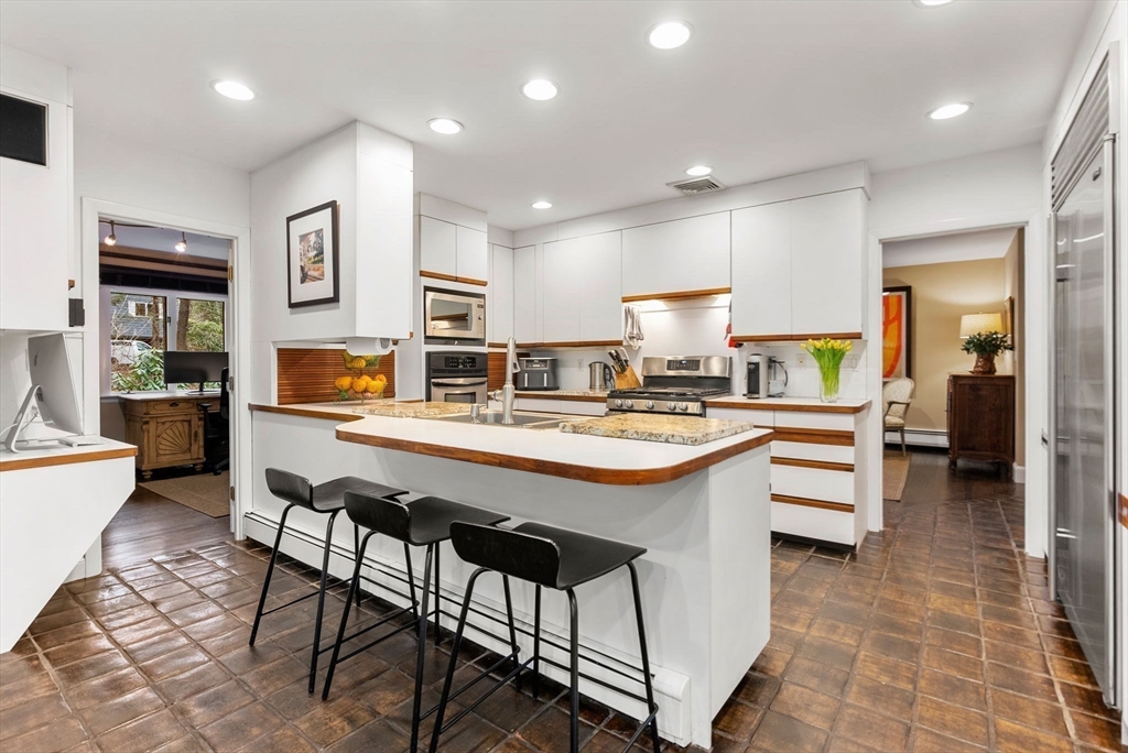 21 Gail Road Weston, MA 02493 - Photo 11 of 37 a kitchen with stainless steel appliances kitchen island granite countertop a sink and cabinets