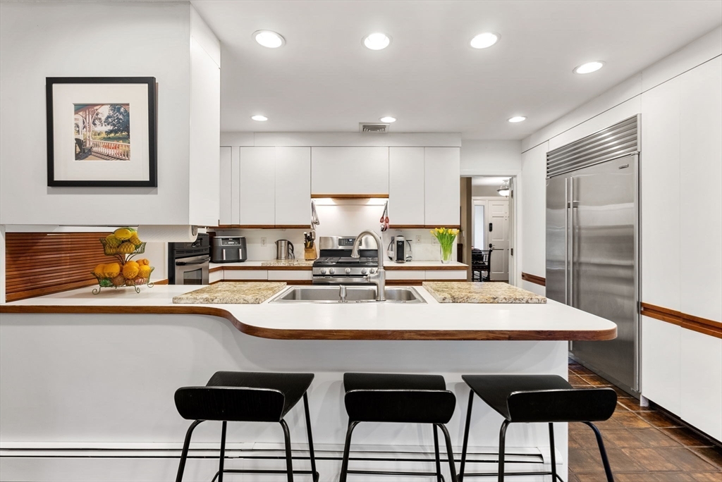 21 Gail Road Weston, MA 02493 - Photo 14 of 37 a large kitchen with a table and chairs