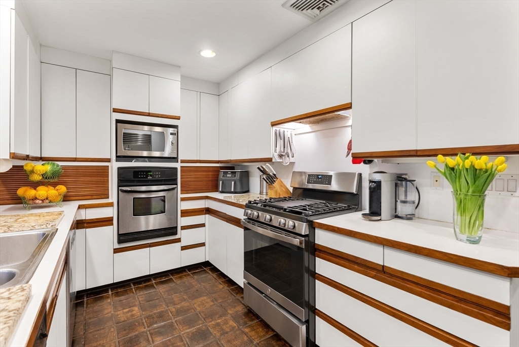 21 Gail Road Weston, MA 02493 - Photo 15 of 37 a kitchen with stainless steel appliances a stove and a refrigerator
