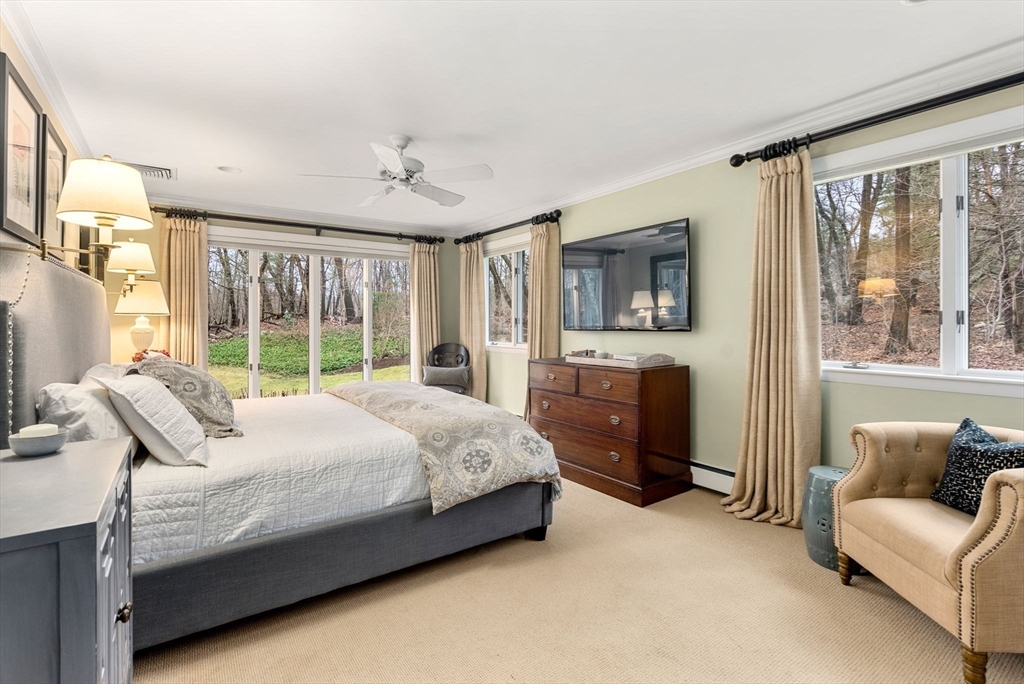 21 Gail Road Weston, MA 02493 - Photo 20 of 37 a spacious bedroom with a bed couch and a window