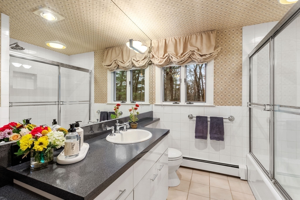 21 Gail Road Weston, MA 02493 - Photo 30 of 37 a bathroom with a sink a vanity and a mirror