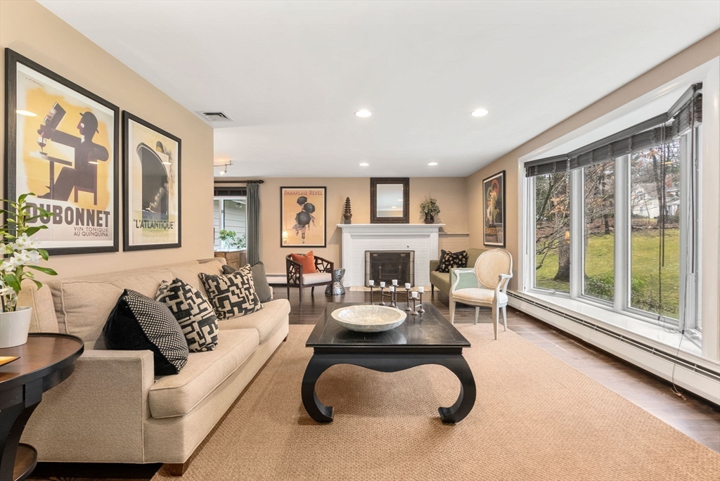 21 Gail Road Weston, MA 02493 - Photo 5 of 37 a living room with furniture a large window and a fireplace