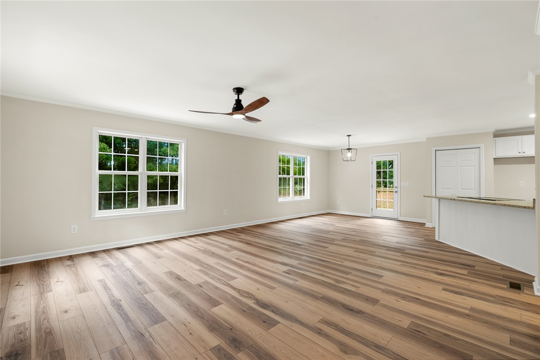 131 Lockaby Road Pelzer, SC 29669 - Photo 13 of 50 This expansive great room seamlessly connects living and kitchen areas with elegant hardwood flooring.