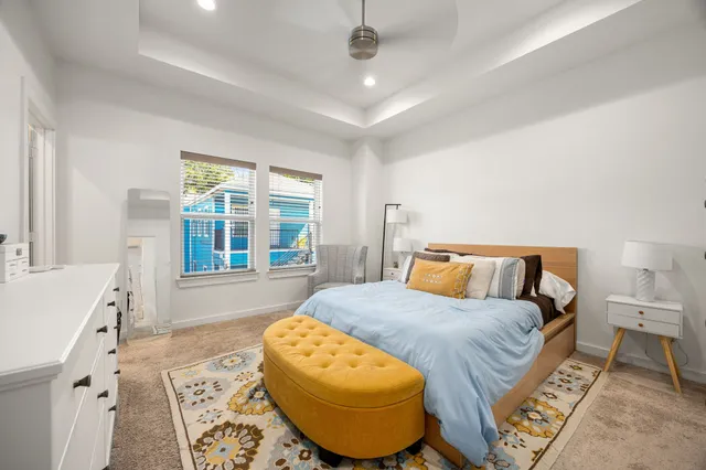 a spacious bedroom with a bed and a window