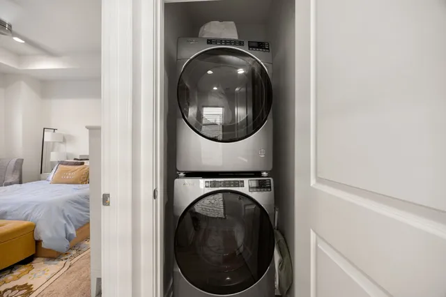 a view of a bedroom with washer and dryer