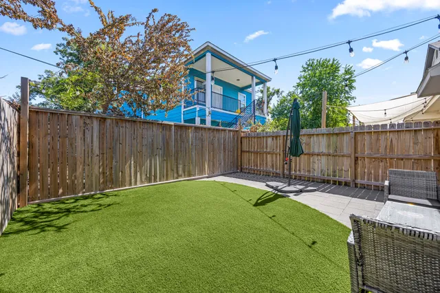 a view of backyard with wooden fence and a cabin