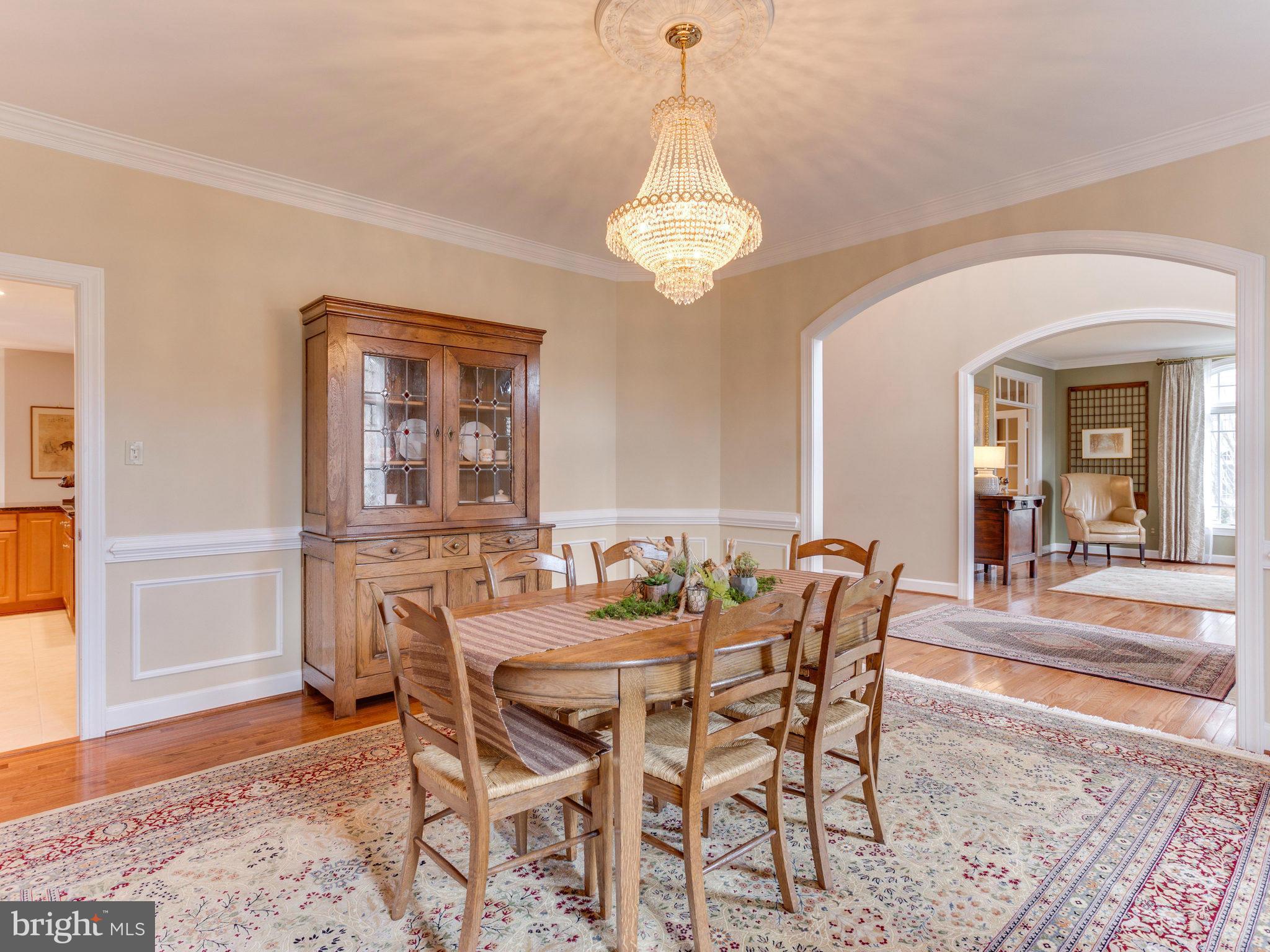 11107 Chessington Place Reston, VA 20194 - Photo 14 of 30 a dining room with furniture a chandelier and wooden floor