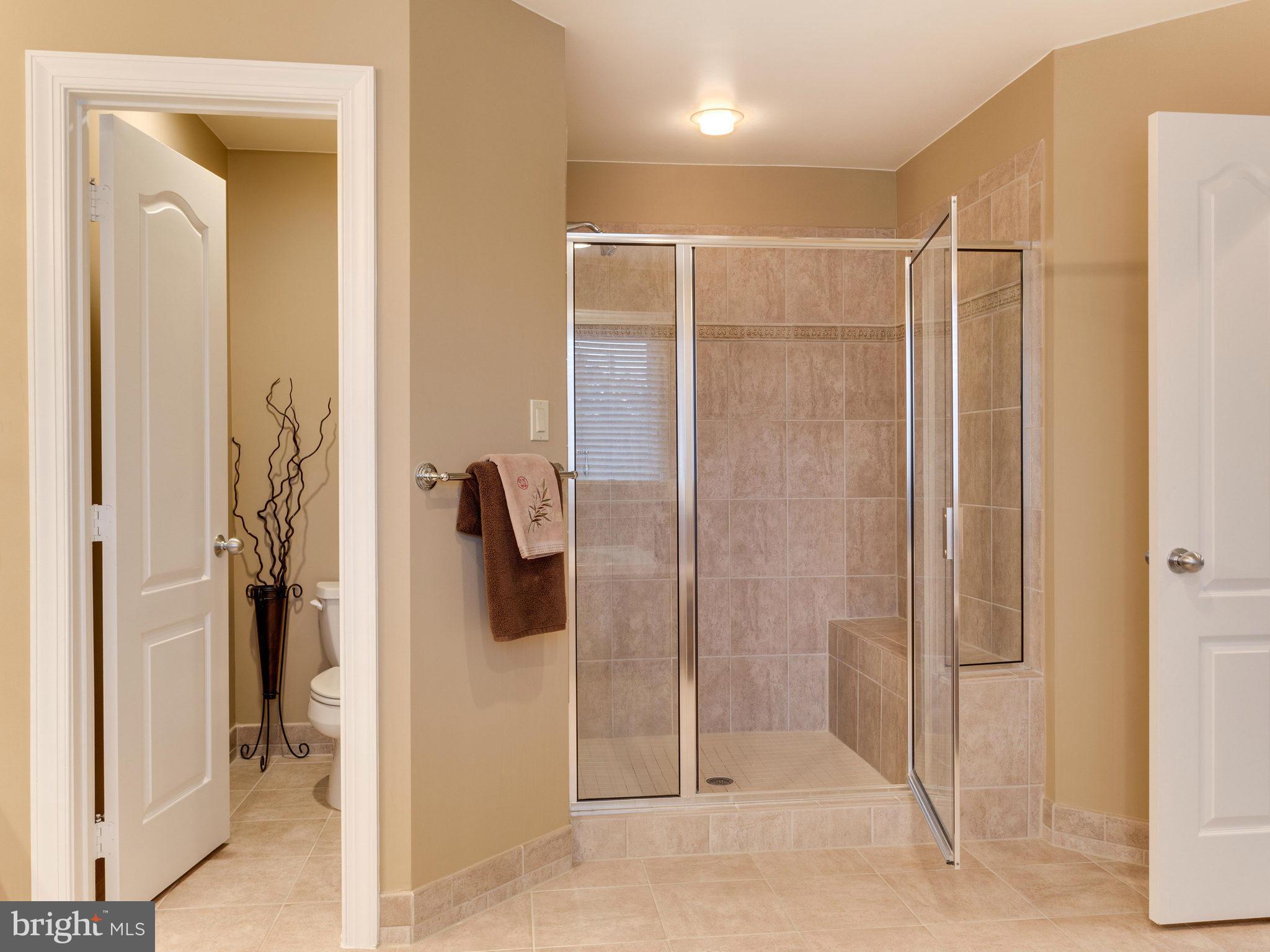 11107 Chessington Place Reston, VA 20194 - Photo 20 of 30 a bathroom with a shower and a glass door