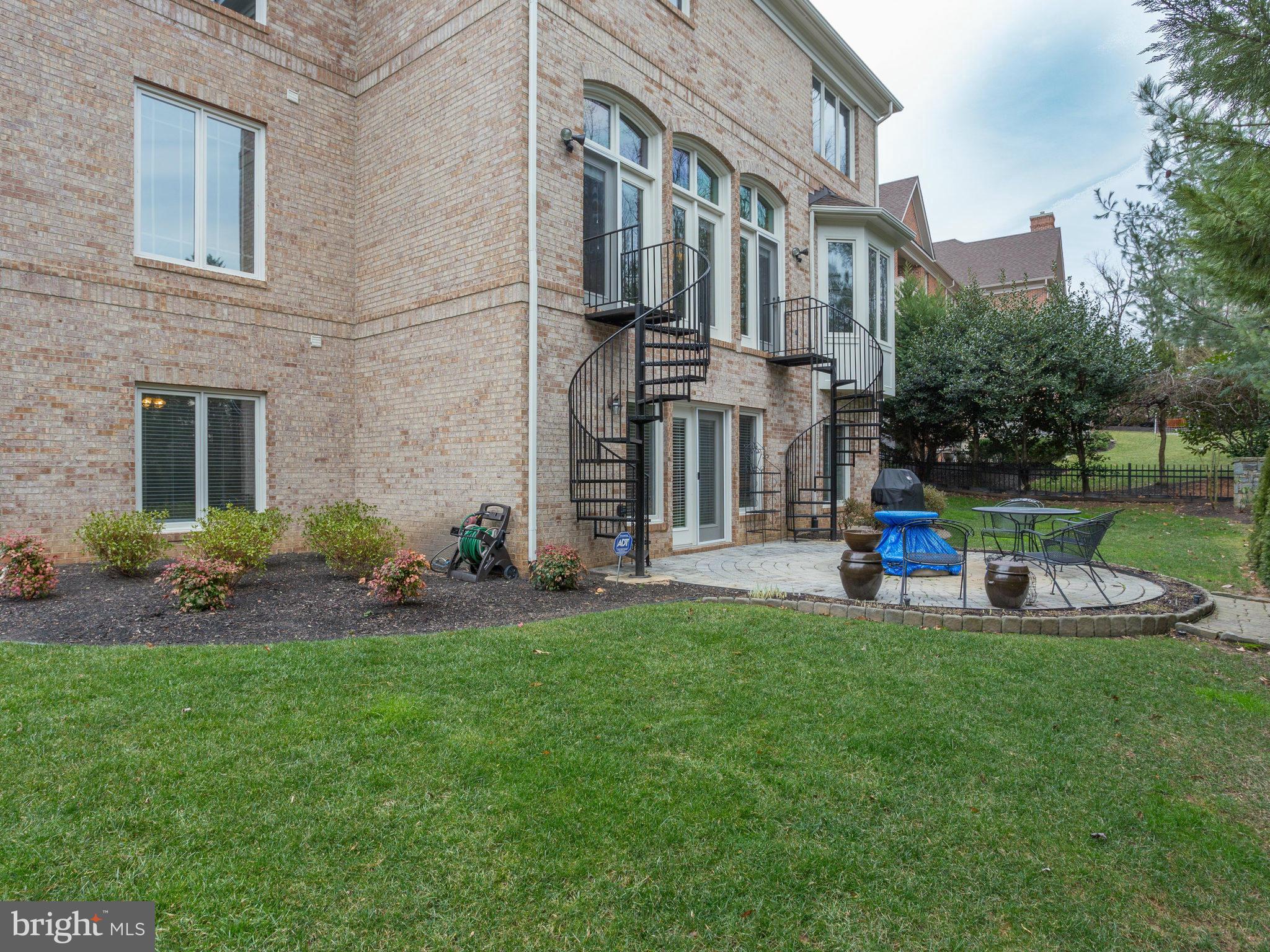 11107 Chessington Place Reston, VA 20194 - Photo 29 of 30 a view of a building with a yard and sitting area