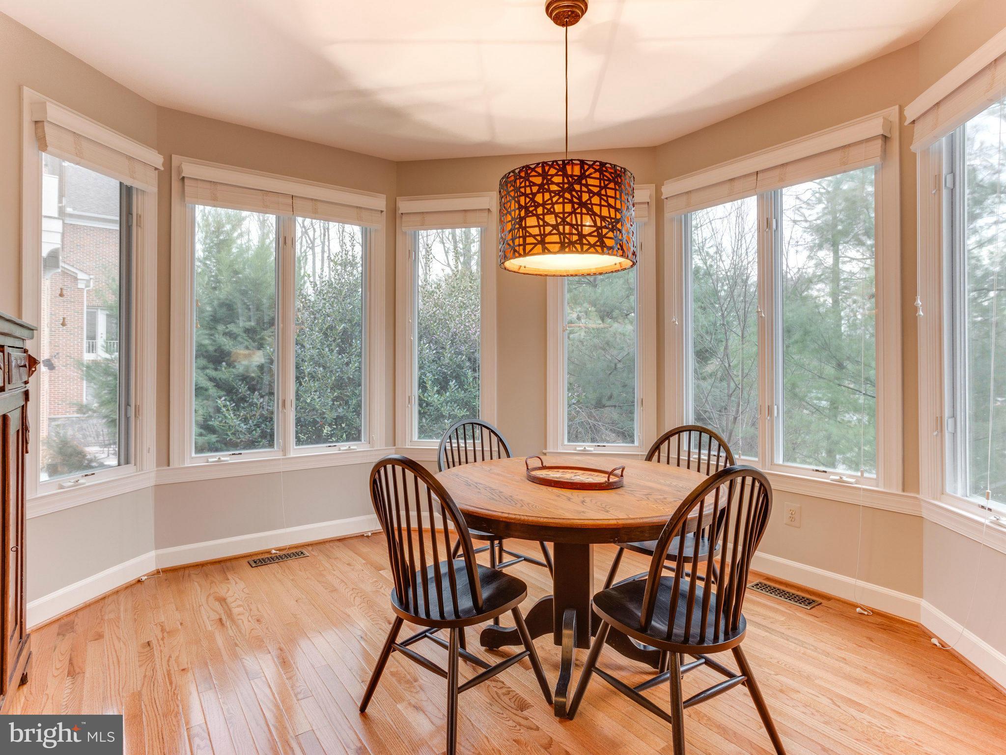 11107 Chessington Place Reston, VA 20194 - Photo 10 of 30 a view of a dining room with furniture window and wooden floor