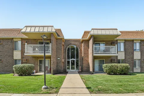 a view of a brick house with a yard