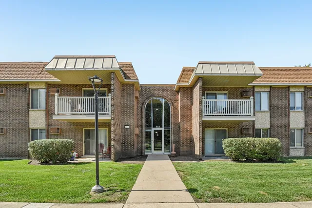 a view of a brick house with a yard