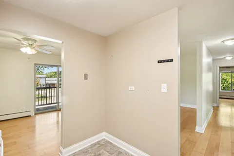 a view of a room with wooden floor and a bathroom