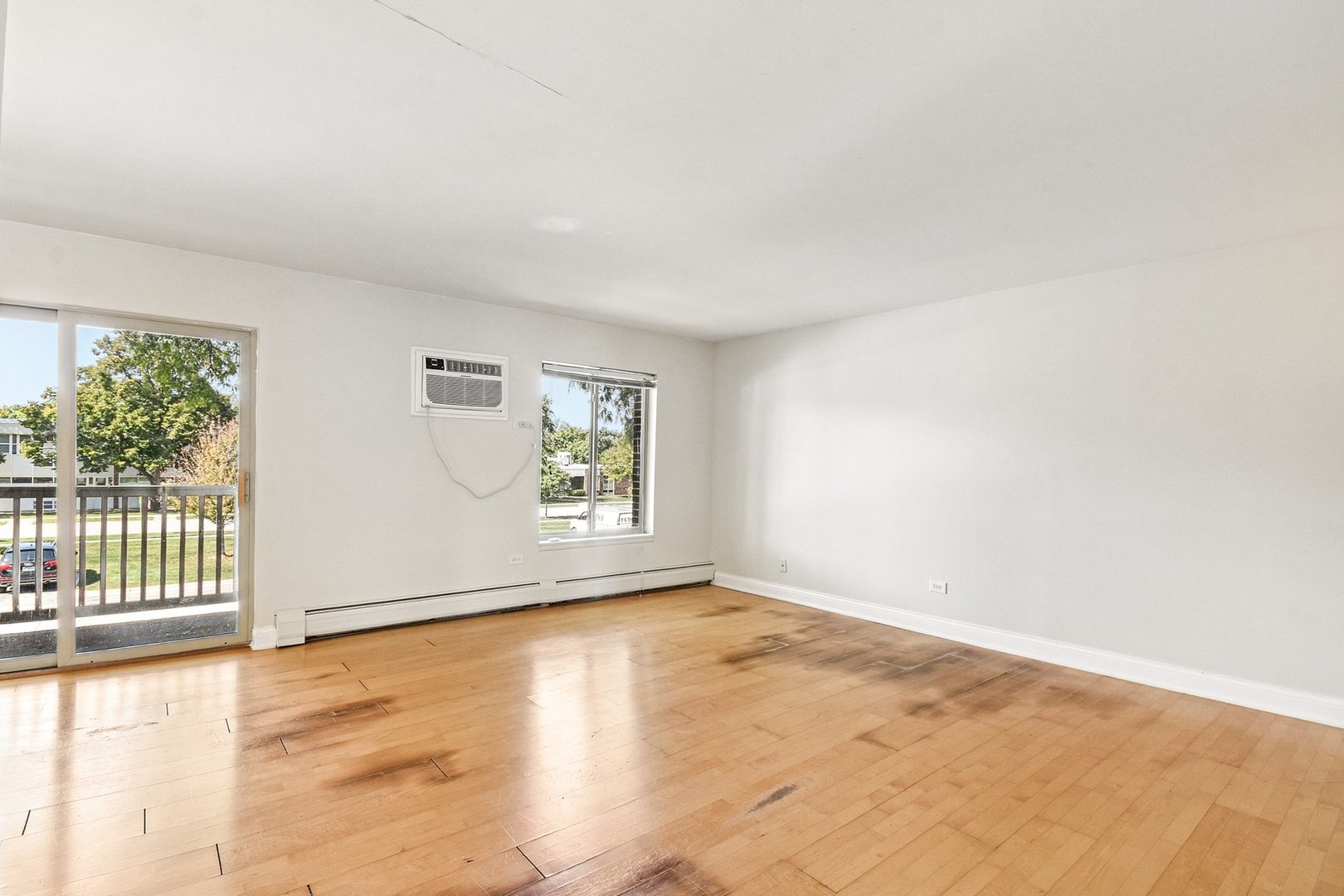 461 North Jonathan Drive, Unit 202 Palatine, IL 60074 - Photo 14 of 23 an empty room with wooden floor and windows