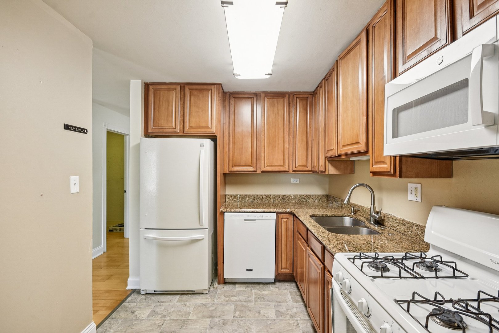 461 North Jonathan Drive, Unit 202 Palatine, IL 60074 - Photo 6 of 23 a kitchen with a refrigerator a sink and a stove