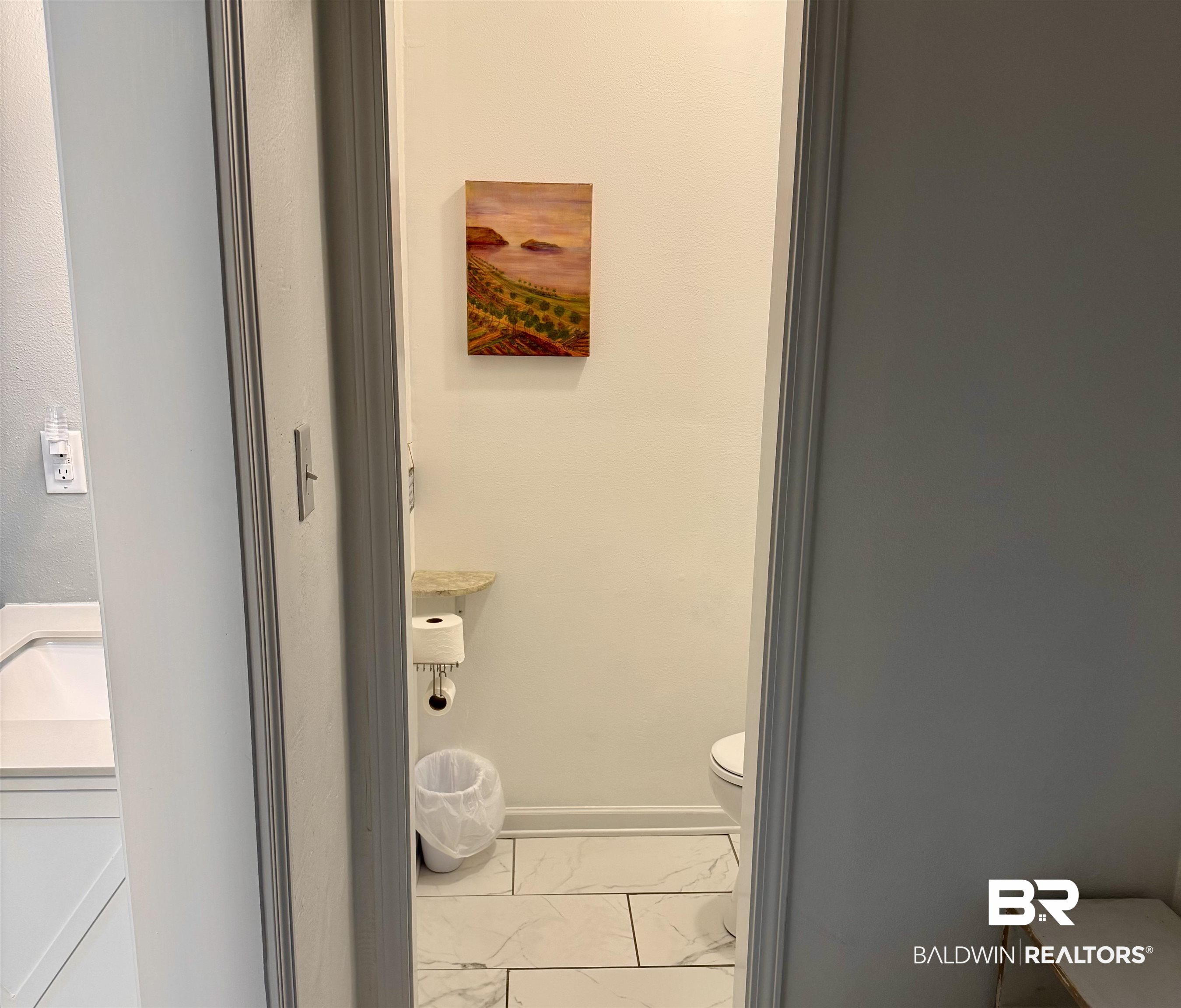 1302 Oak Street Daphne, AL 36526 - Photo 29 of 34 Bathroom featuring light marble finish floors, vanity, and washer / dryer