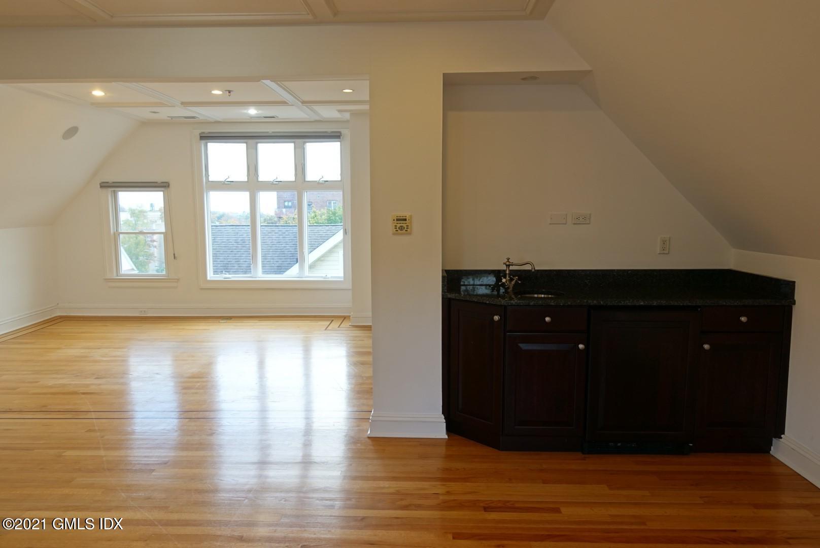 23 Benedict Place, Unit 3 Greenwich, CT 06830 - Photo 12 of 16 a view of an empty room with wooden floor and a window