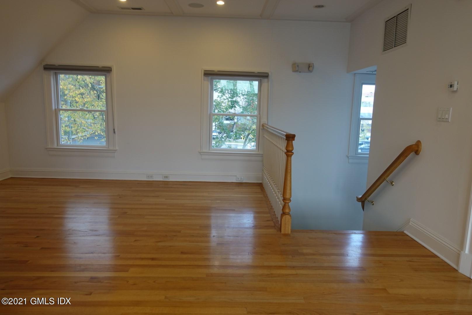 23 Benedict Place, Unit 3 Greenwich, CT 06830 - Photo 13 of 16 a view of room with window and wooden floor