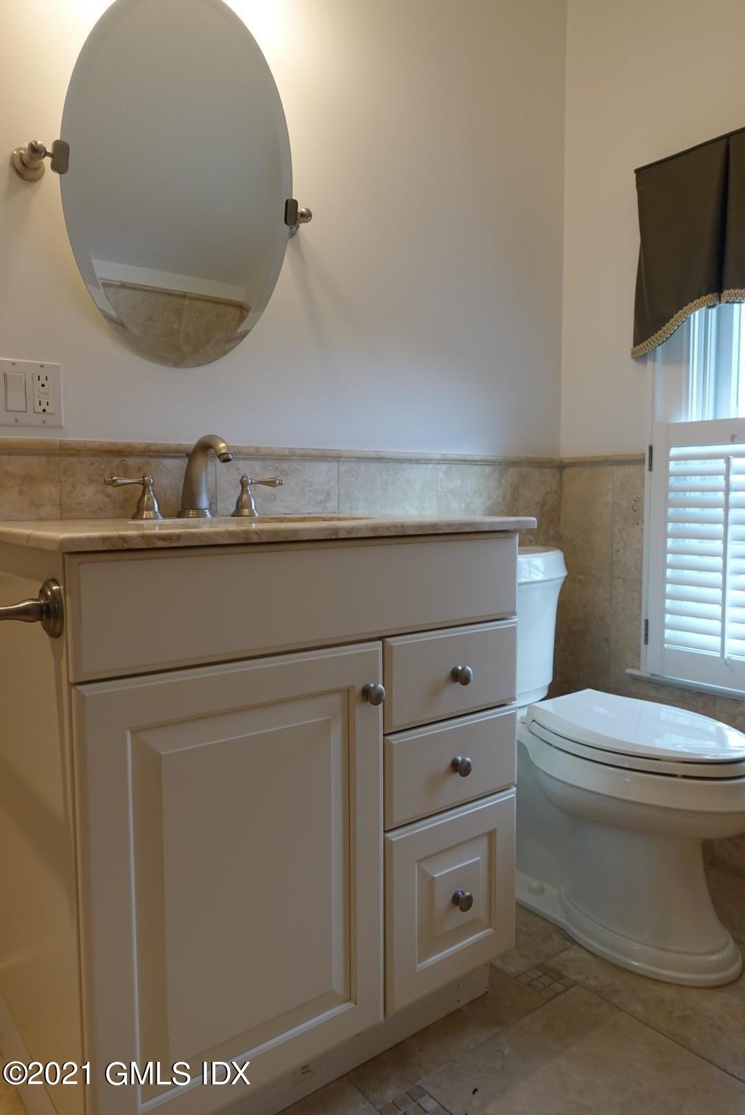 23 Benedict Place, Unit 3 Greenwich, CT 06830 - Photo 14 of 16 a bathroom with a toilet a sink and mirror