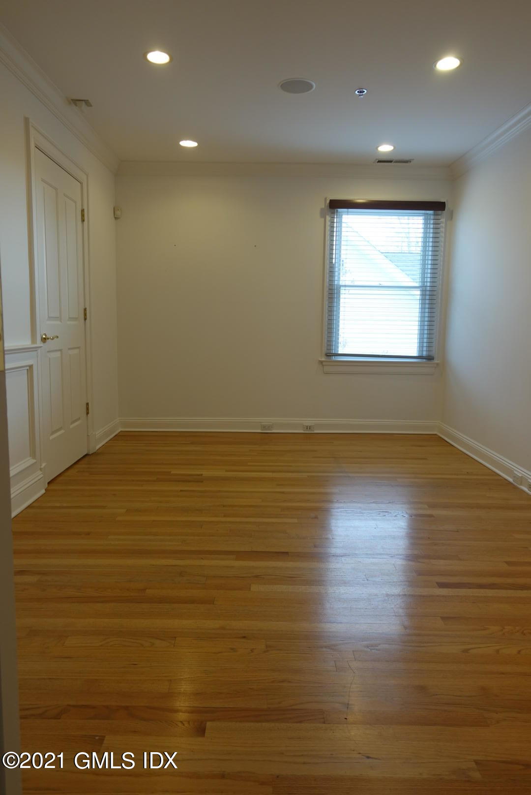 23 Benedict Place, Unit 3 Greenwich, CT 06830 - Photo 3 of 16 an empty room with wooden floor and windows