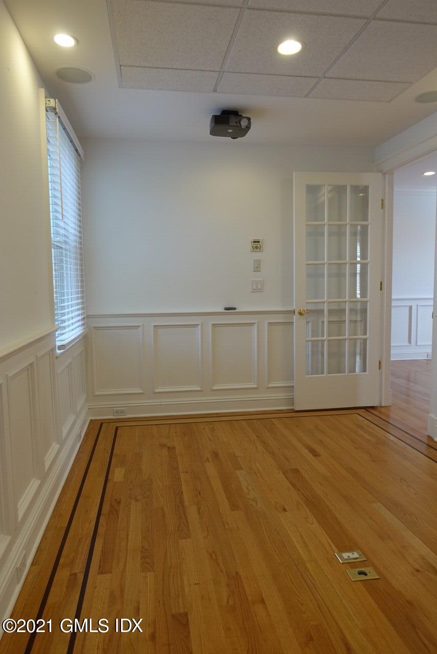 23 Benedict Place, Unit 3 Greenwich, CT 06830 - Photo 5 of 16 a view of an empty room with wooden floor and a window