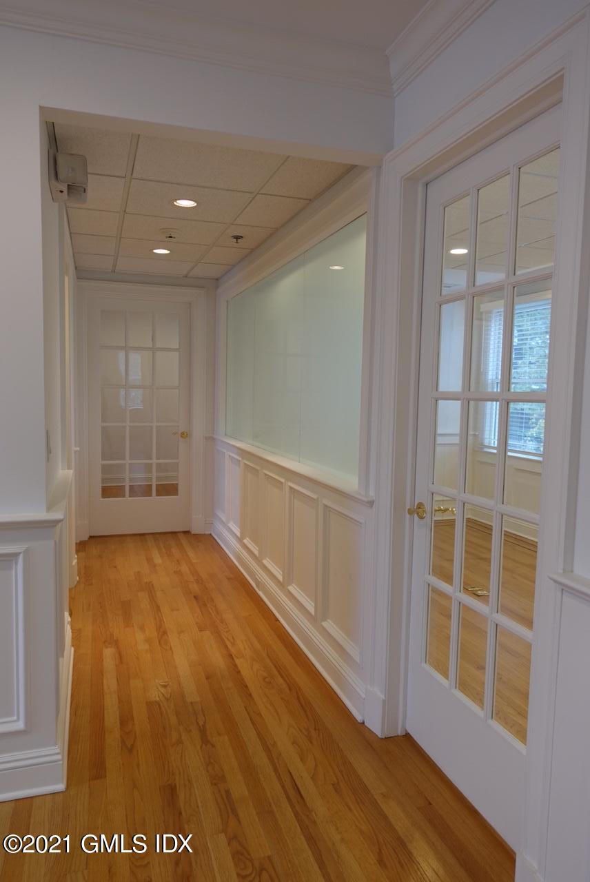 23 Benedict Place, Unit 3 Greenwich, CT 06830 - Photo 6 of 16 a view of an empty room with wooden floor and a window