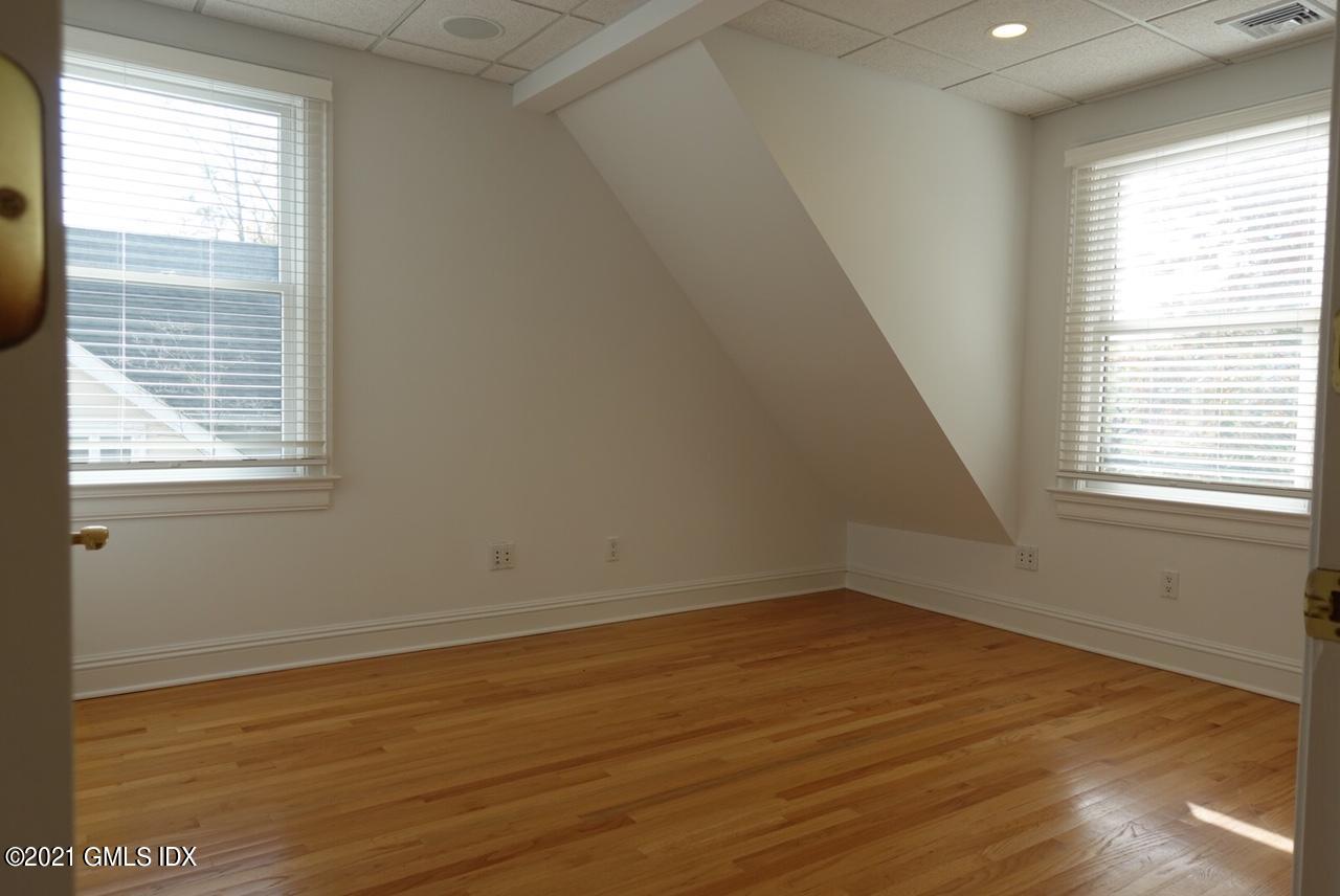 23 Benedict Place, Unit 3 Greenwich, CT 06830 - Photo 9 of 16 a view of a room with wooden floor and windows