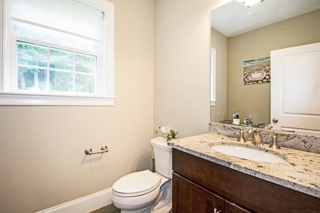 127 Lowell Street Lexington, MA 02420 - Photo 12 of 30 a bathroom with a granite countertop sink toilet and mirror