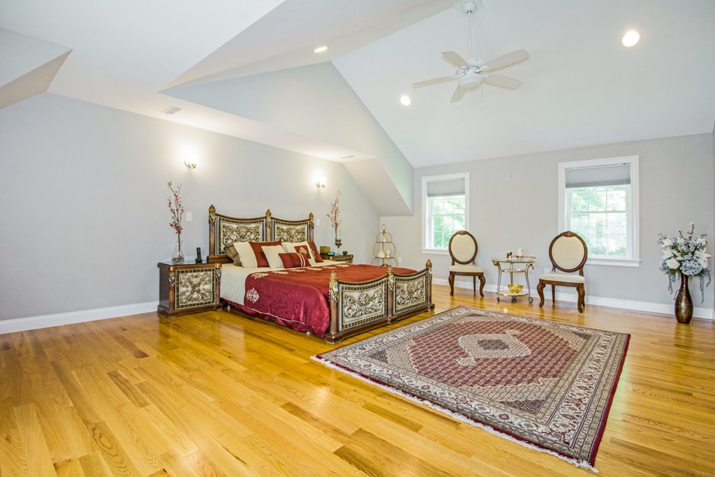 127 Lowell Street Lexington, MA 02420 - Photo 14 of 30 a bedroom with a bed a dresser and potted plant