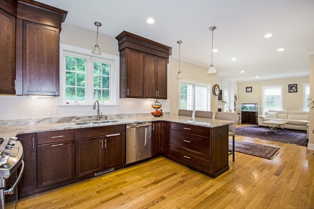 127 Lowell Street Lexington, MA 02420 - Photo 6 of 30 a large kitchen with stainless steel appliances granite countertop a sink and wooden cabinets