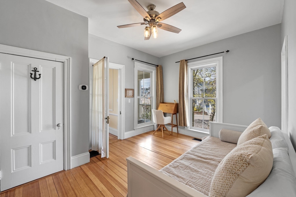 90 Puritan Road Swampscott, MA 01907 - Photo 20 of 42 a spacious bedroom with a bed and a chandelier
