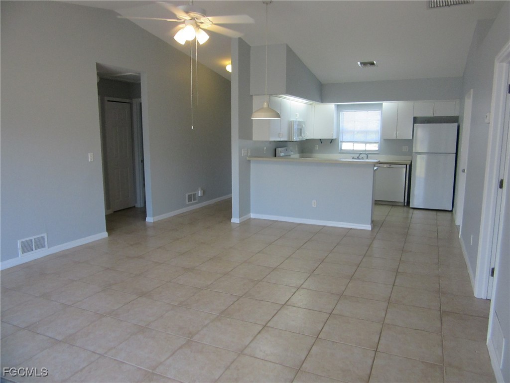 4544-4546 28th Street Southwest Lehigh Acres, FL 33973 - Photo 13 of 23 a view of a kitchen with an empty space and cabinets