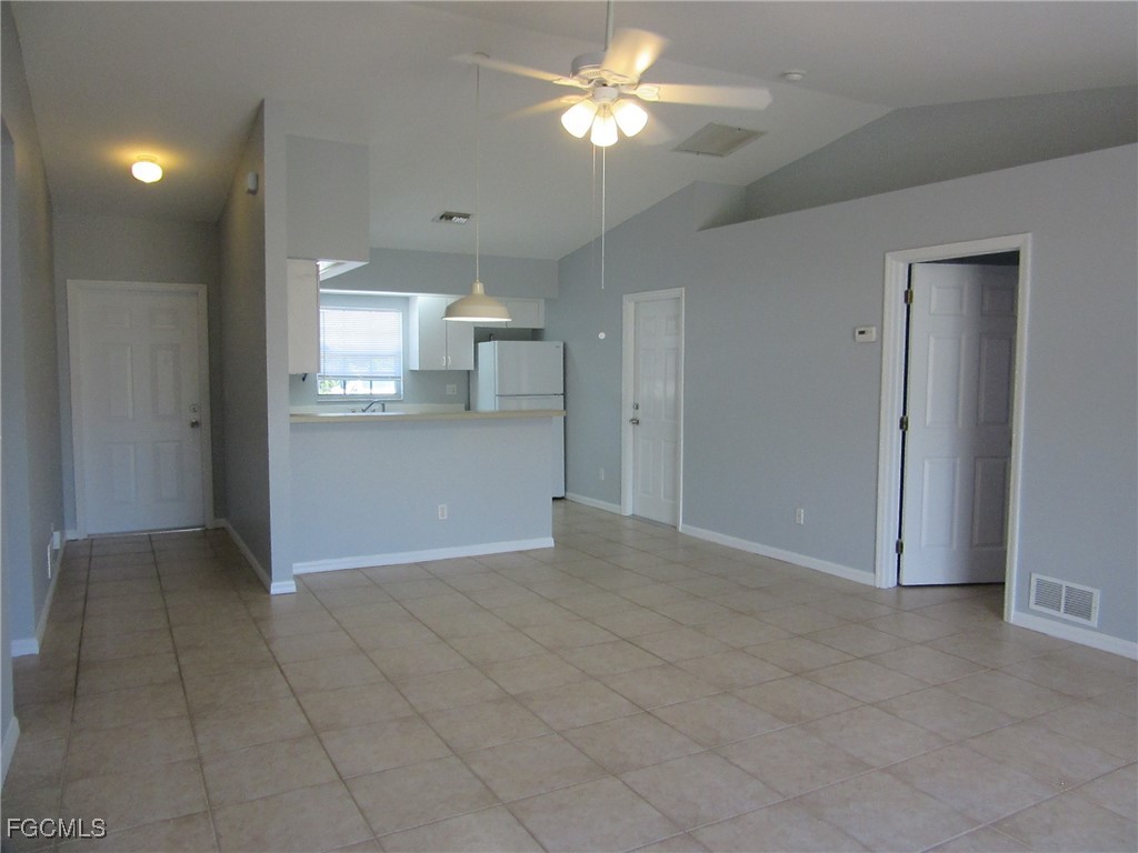 4544-4546 28th Street Southwest Lehigh Acres, FL 33973 - Photo 14 of 23 a view of a kitchen with a sink and a chandelier fan