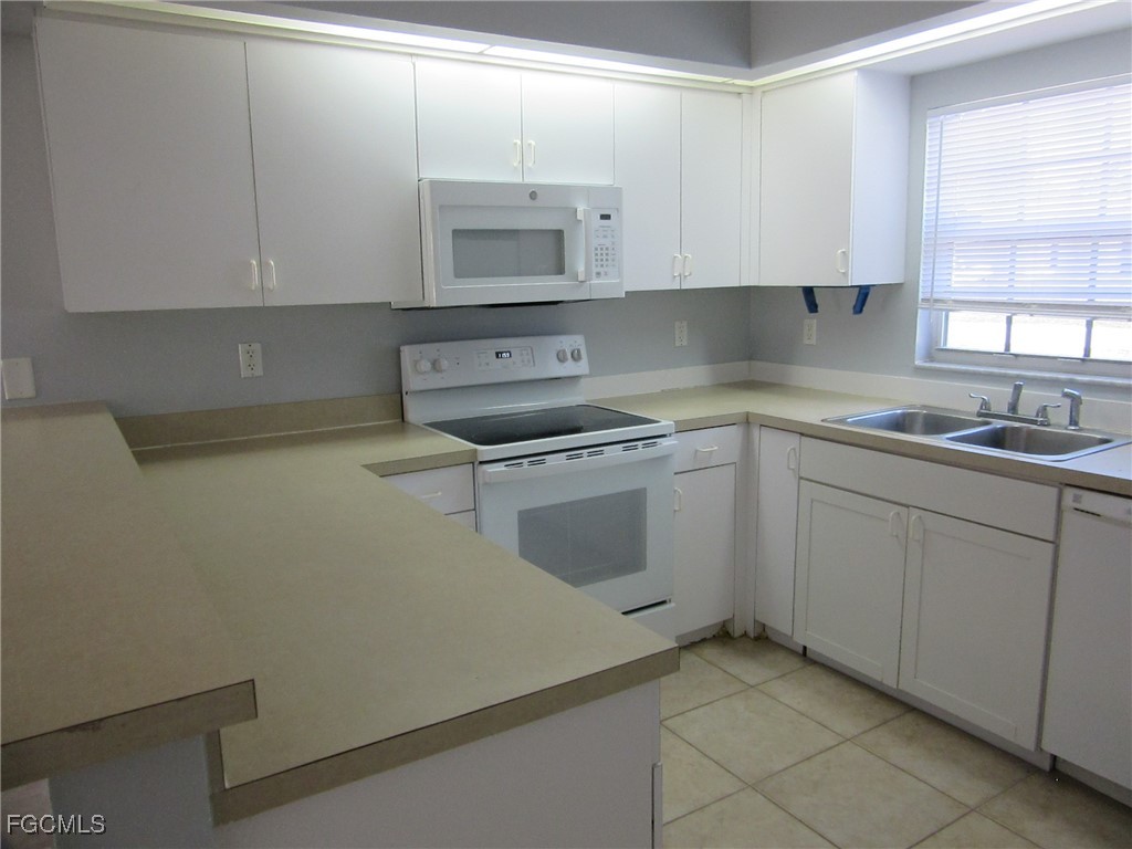 4544-4546 28th Street Southwest Lehigh Acres, FL 33973 - Photo 16 of 23 a kitchen with sink cabinets and window