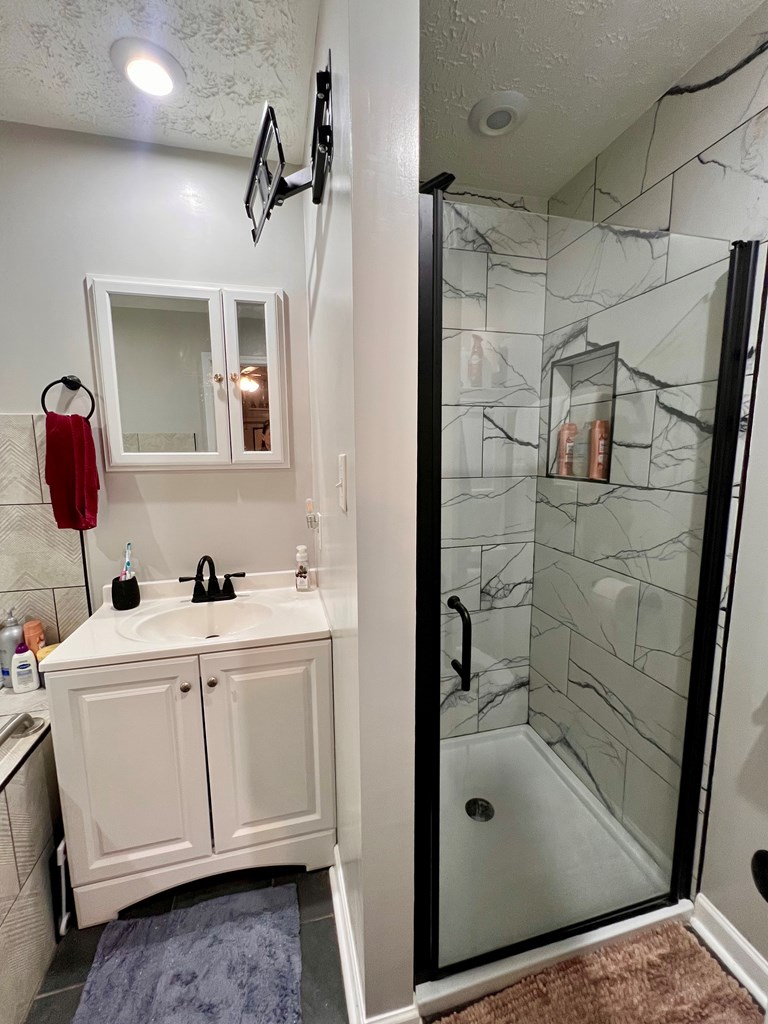 263 Nightingale Drive Columbus, GA 31906 - Photo 11 of 19 a bathroom with a shower sink and mirror