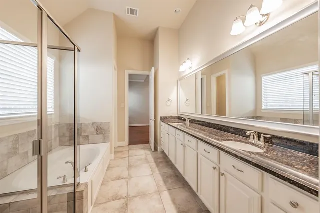 a spacious bathroom with a granite countertop sink mirror and double