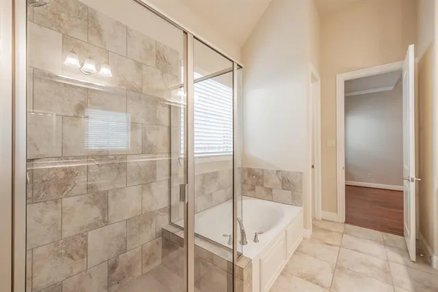 a bathroom with a bathtub and a shower