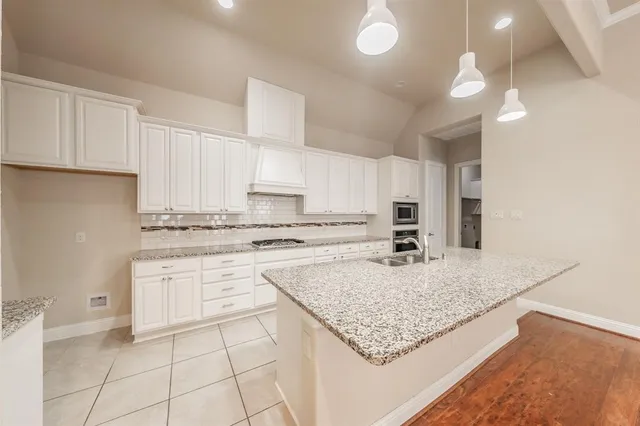 a kitchen with a stove refrigerator and cabinets