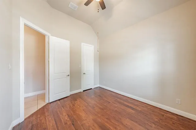 a view of a room with wooden floor