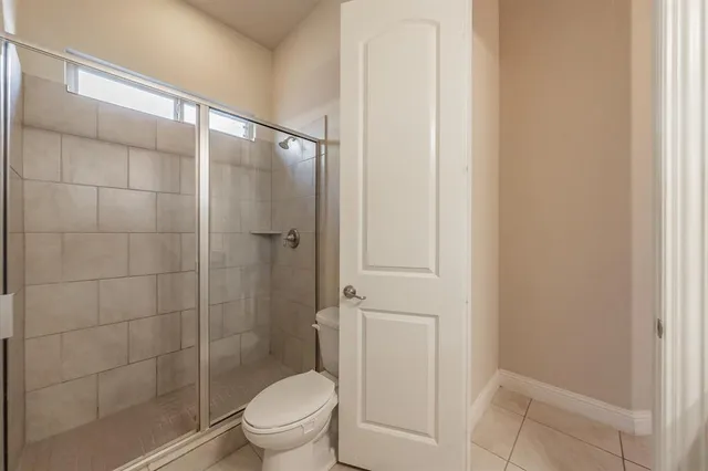 a bathroom with a shower and a toilet