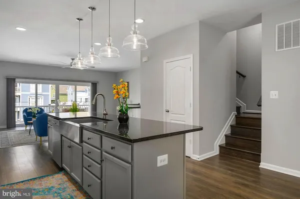 a view of a dining room with furniture a chandelier and wooden floor