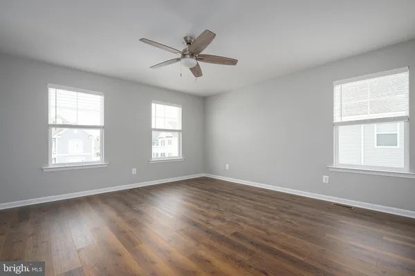 a view of a hallway with wooden floor and entryway