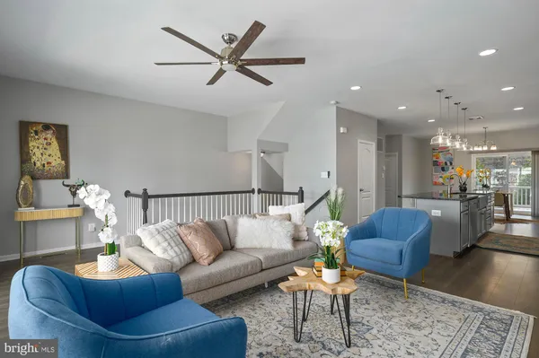 a living room with furniture and a view of kitchen