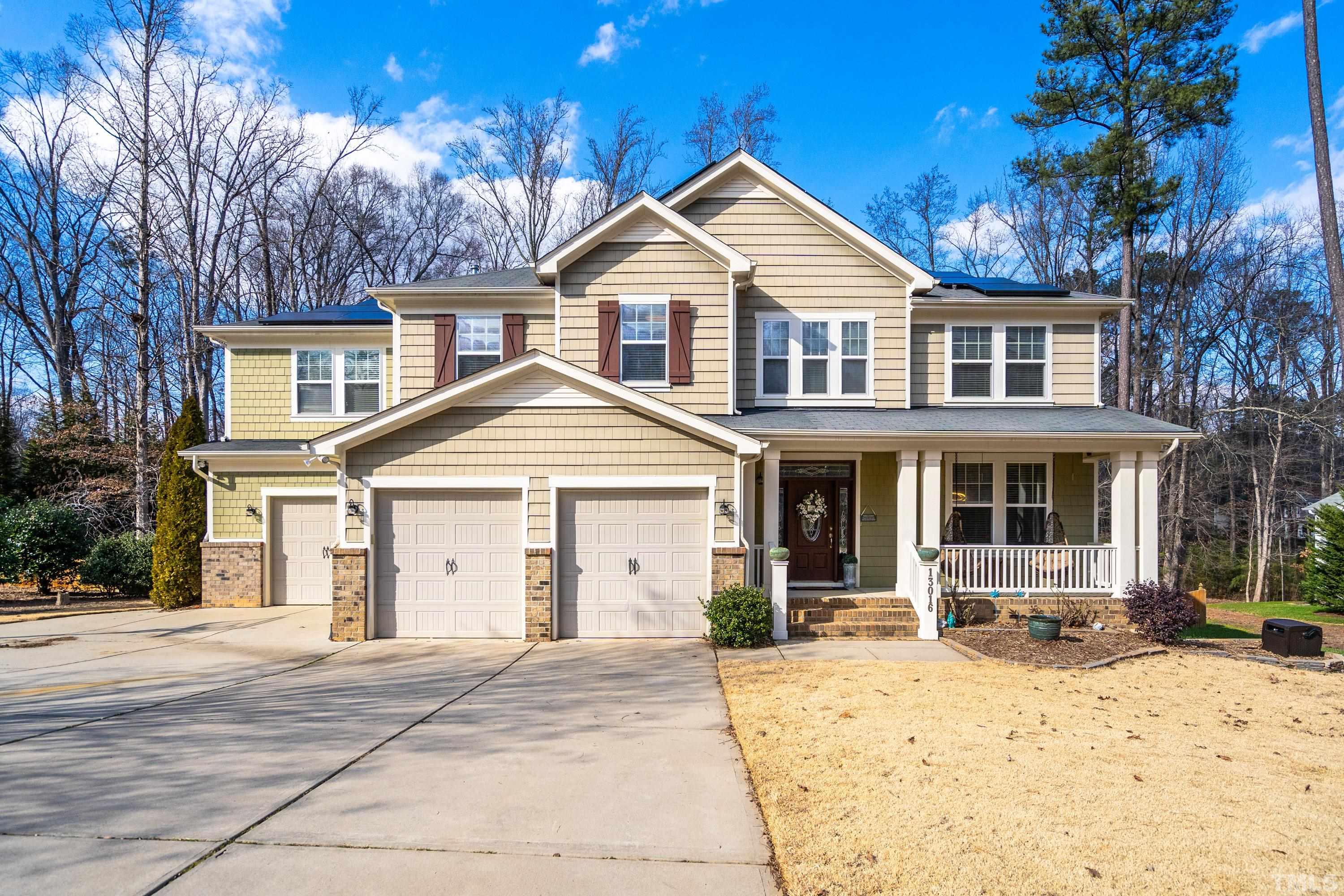 13016 Saxon Way Raleigh, NC 27613 - Photo 17 of 49 a front view of a house with a yard
