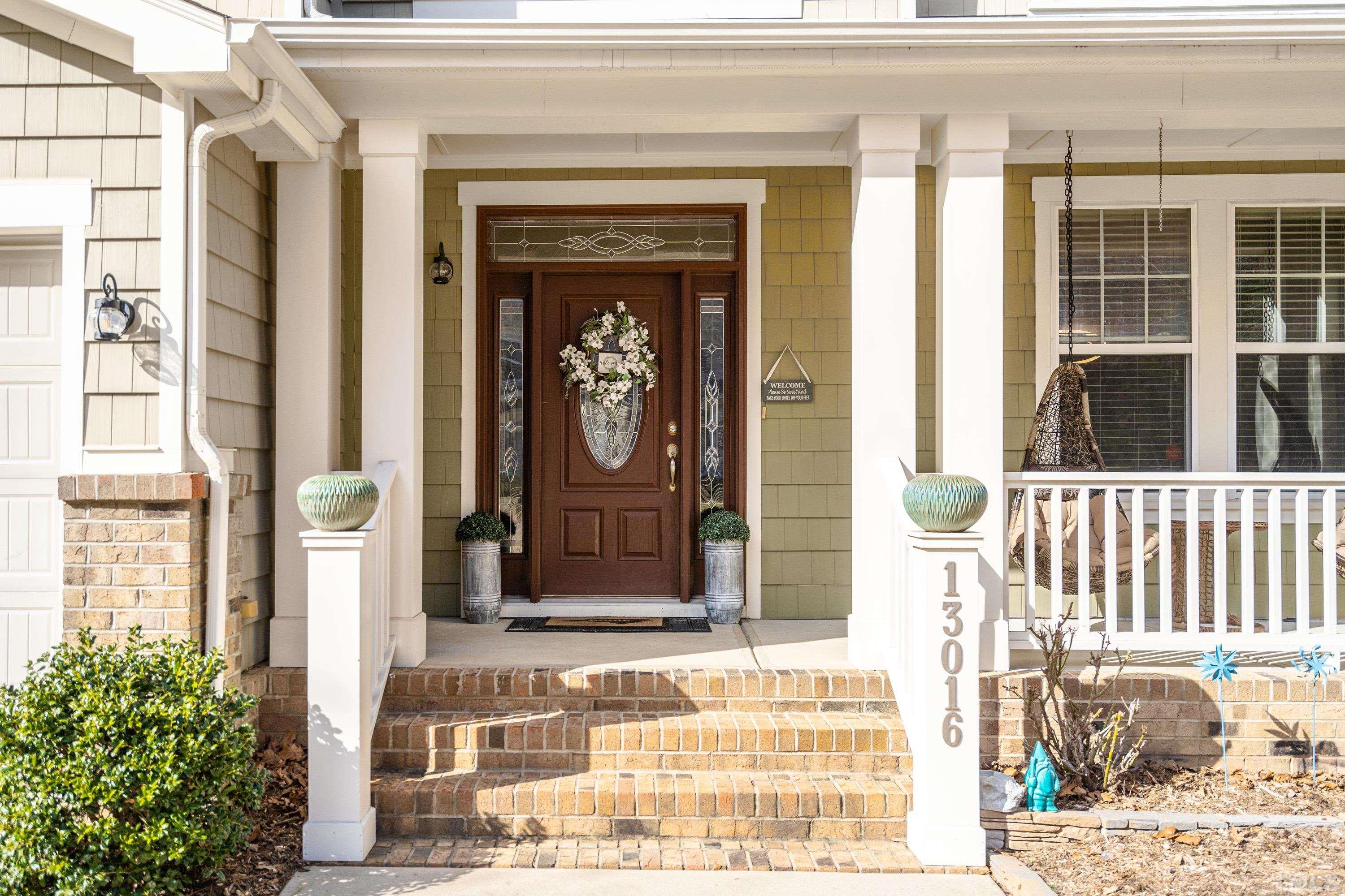 13016 Saxon Way Raleigh, NC 27613 - Photo 19 of 49 a front view of a house with a garden