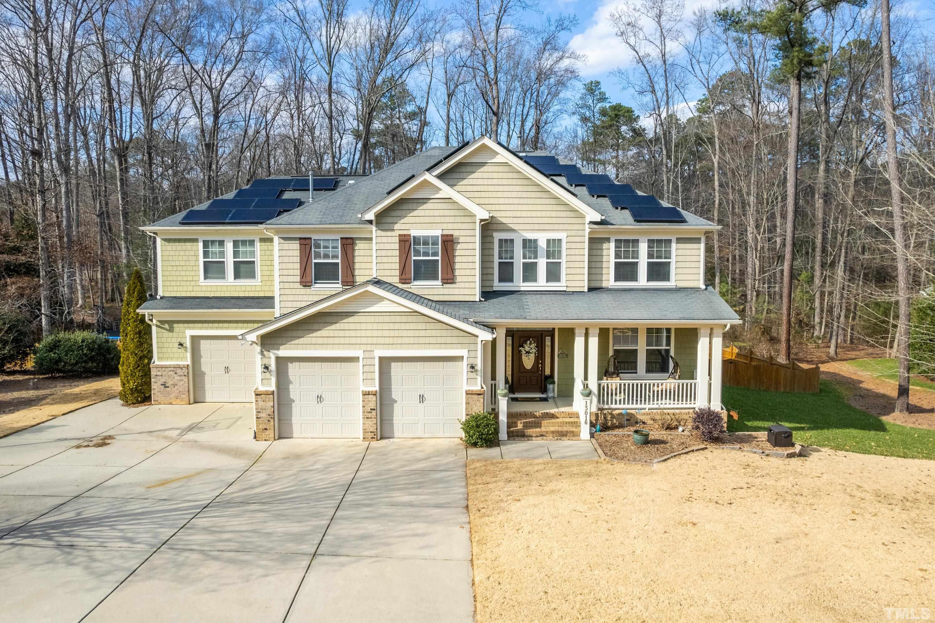 13016 Saxon Way Raleigh, NC 27613 - Photo 2 of 49 a front view of a house with a yard